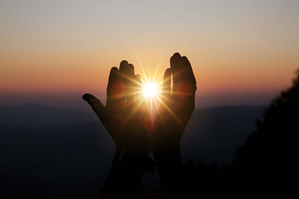 spiritual-prayer-hands-sun-shine-with-blurred-beautiful-sunset 1